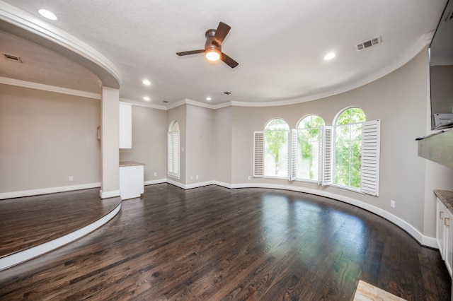 unfurnished living room with ceiling fan, a textured ceiling, crown molding, and dark hardwood / wood-style flooring