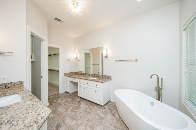 bathroom with vanity and a tub