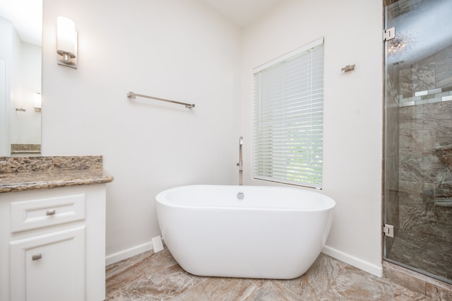 bathroom with vanity and separate shower and tub