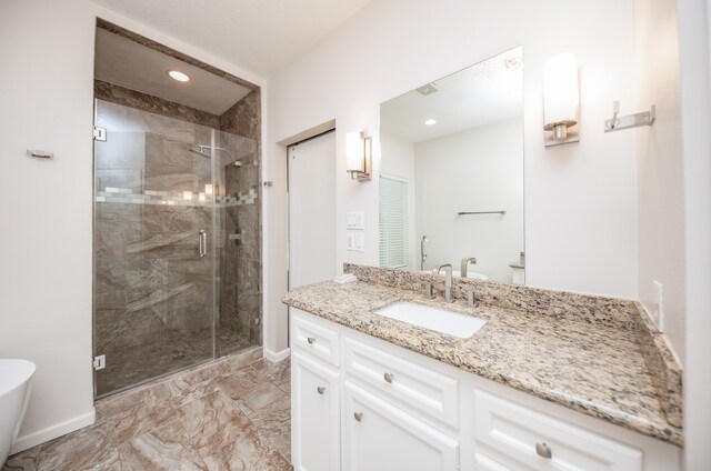 bathroom featuring vanity and a shower with shower door