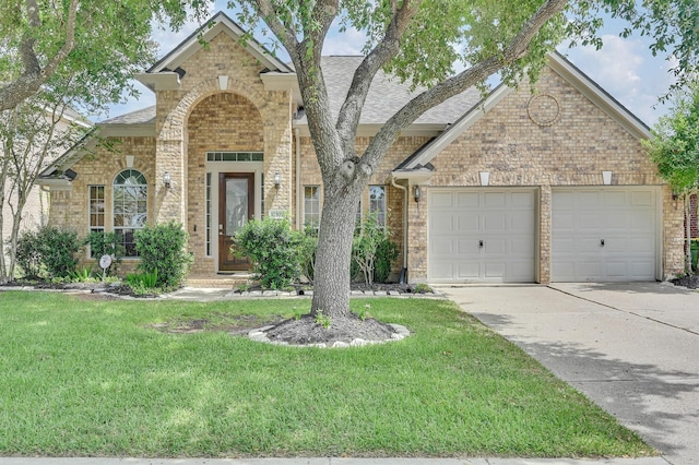 view of property featuring a garage and a front yard