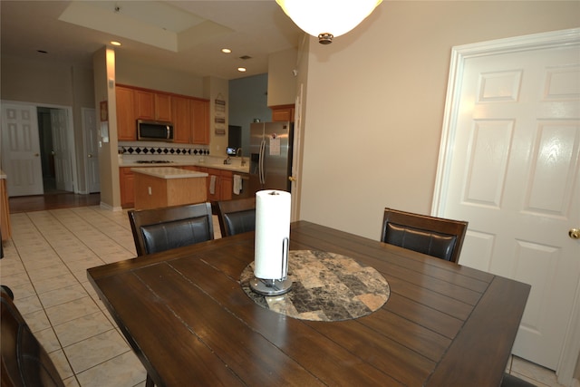 tiled dining room featuring sink