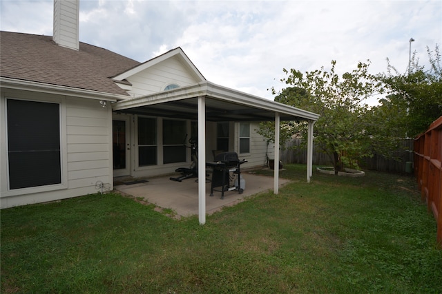 rear view of property with a patio and a yard