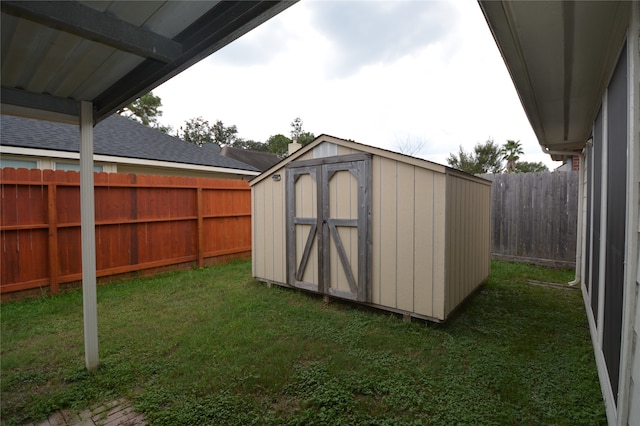 view of outbuilding with a yard