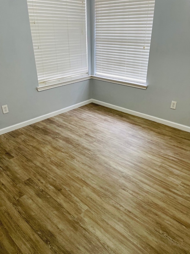 empty room with hardwood / wood-style flooring