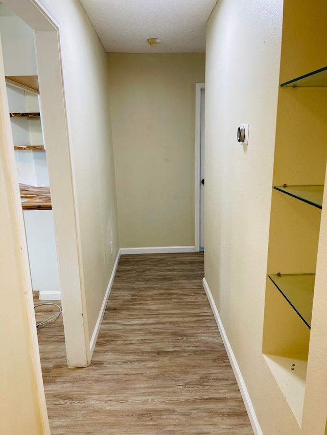 corridor with light hardwood / wood-style flooring