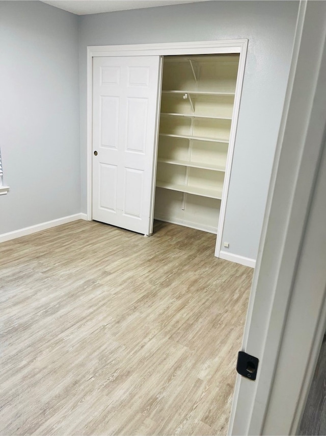 unfurnished bedroom featuring light wood-type flooring