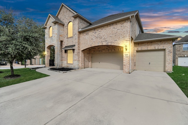 french provincial home featuring a garage