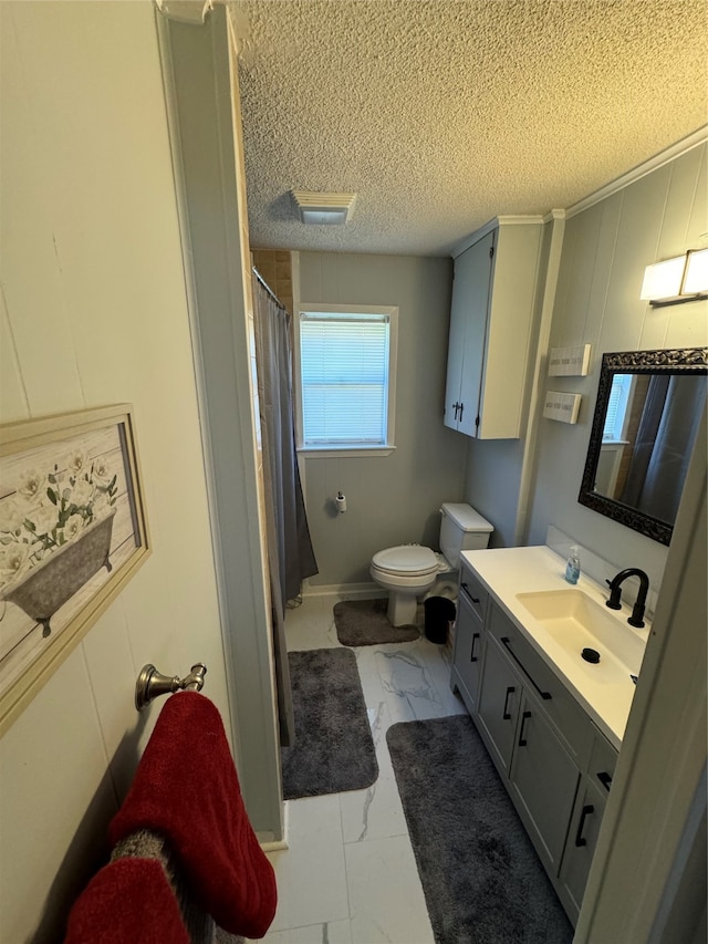 bathroom with a shower with curtain, vanity, a textured ceiling, and toilet