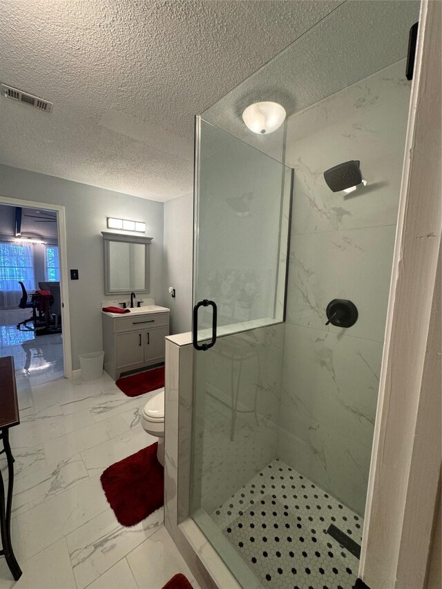 323 Mallard Pt, Livingston, TX 77351 - full bath with a textured ceiling, vanity, visible vents, marble finish floor, and a marble finish shower