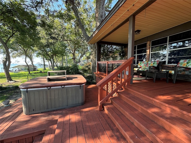 wooden terrace featuring a hot tub