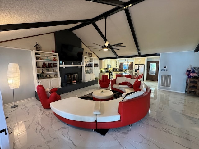 living room with a textured ceiling, vaulted ceiling with beams, and ceiling fan