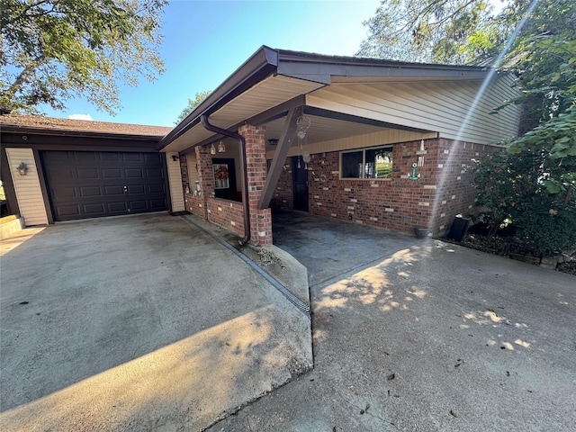 323 Mallard Pt, Livingston, TX 77351 - ranch-style home with brick siding, an attached garage, an attached carport, and driveway