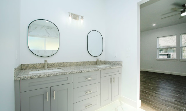 bathroom with ceiling fan, wood-type flooring, and vanity