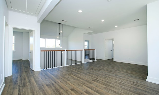 unfurnished room featuring beam ceiling and dark hardwood / wood-style floors