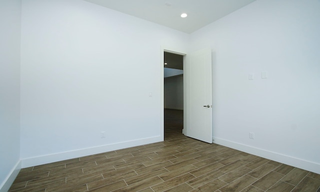 unfurnished room with dark hardwood / wood-style flooring