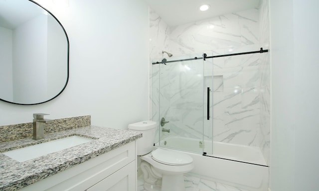 full bathroom featuring vanity, bath / shower combo with glass door, and toilet