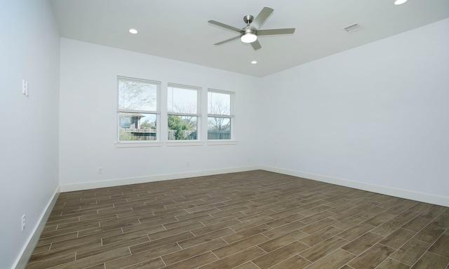 empty room with ceiling fan and dark wood-type flooring