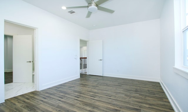 unfurnished room with dark hardwood / wood-style floors and ceiling fan