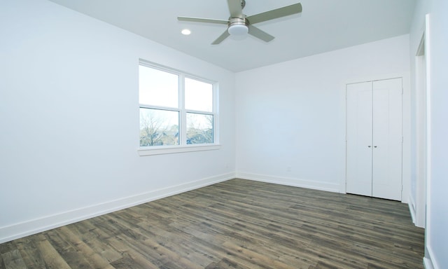 empty room featuring ceiling fan and dark hardwood / wood-style floors