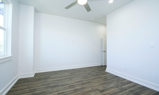 empty room with ceiling fan and dark hardwood / wood-style floors