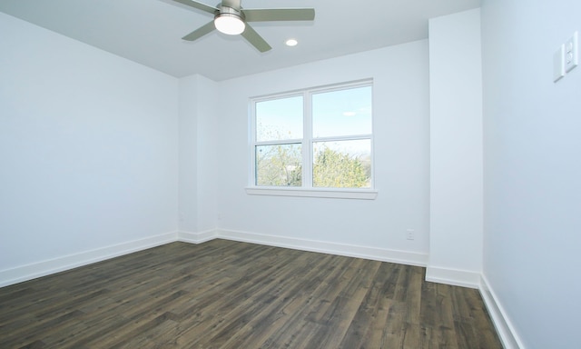 unfurnished room with dark hardwood / wood-style flooring and ceiling fan