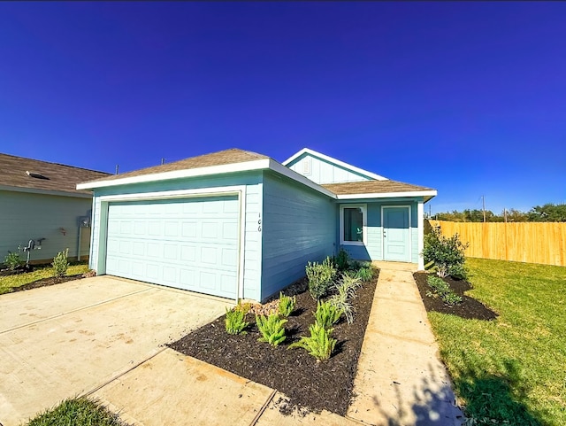 ranch-style house with a garage and a front lawn