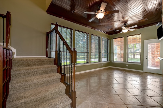 interior space featuring ceiling fan, tile patterned flooring, and a wealth of natural light