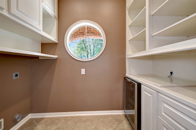 laundry room with wine cooler, hookup for an electric dryer, and light tile patterned floors