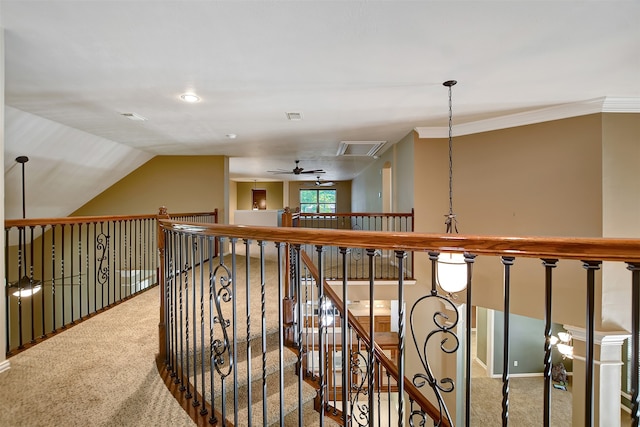 corridor with ornamental molding, carpet flooring, and vaulted ceiling