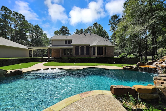 view of pool featuring a lawn and pool water feature