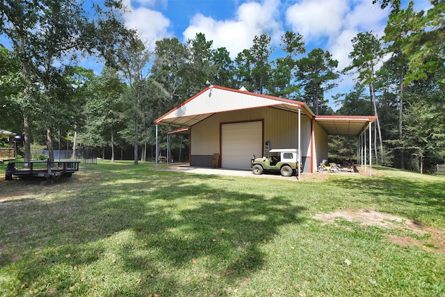 exterior space with a carport, a garage, a yard, and an outbuilding