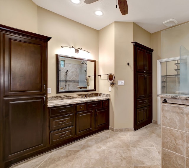 bathroom with ceiling fan, vanity, and a shower