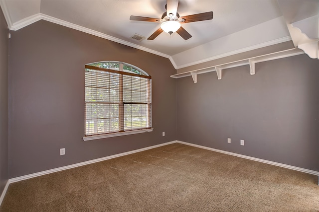 empty room with ornamental molding, vaulted ceiling, and carpet flooring