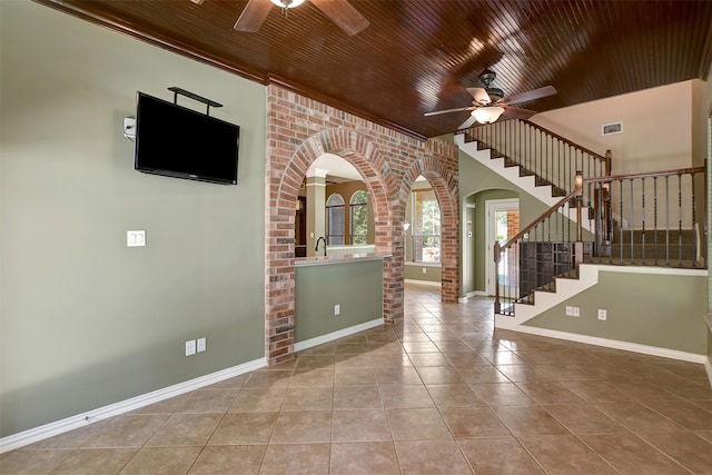 entrance foyer featuring light tile patterned flooring, wood ceiling, sink, and ceiling fan