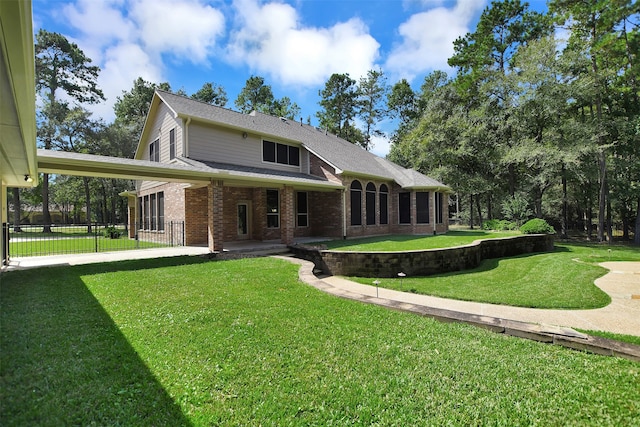 back of house featuring a lawn