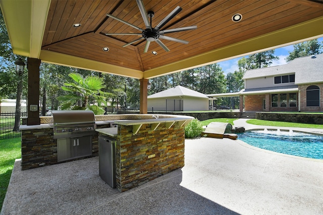 view of patio with area for grilling, ceiling fan, and a fenced in pool