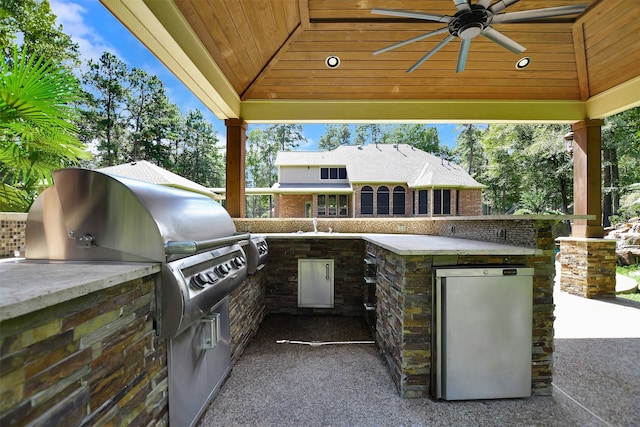 view of patio featuring a gazebo, an outdoor kitchen, and ceiling fan