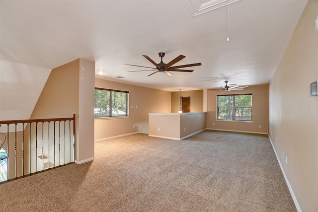 spare room featuring light carpet, ceiling fan, and vaulted ceiling