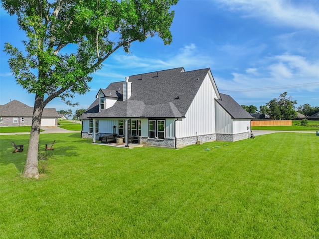 rear view of property with a patio and a yard