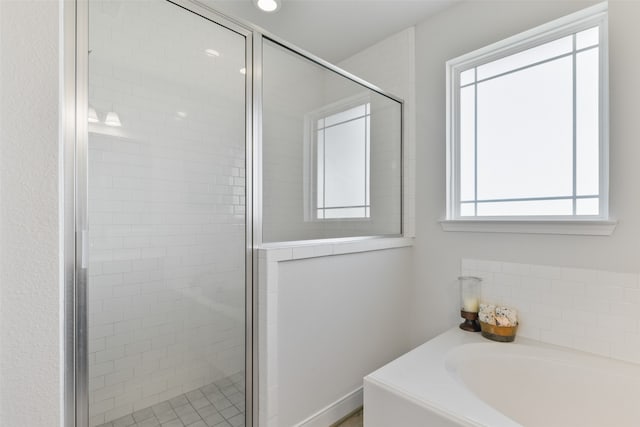 bathroom with shower with separate bathtub