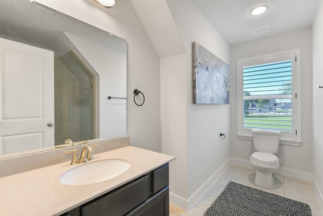 bathroom featuring vanity, tiled shower, toilet, and tile patterned floors