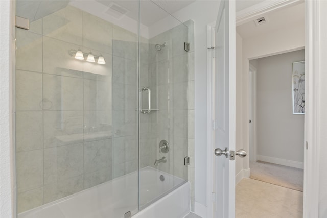 bathroom featuring combined bath / shower with glass door and tile patterned flooring