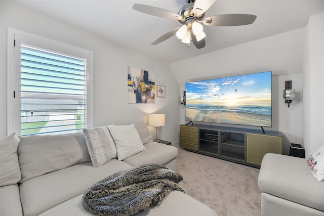 carpeted living room featuring ceiling fan and lofted ceiling