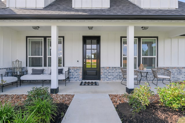 view of exterior entry featuring a porch