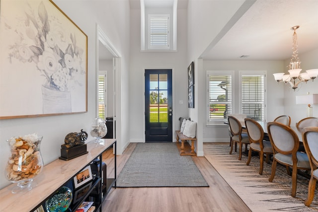 entryway with an inviting chandelier and hardwood / wood-style flooring