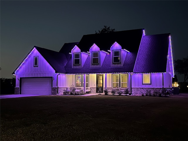 cape cod home with a porch, a garage, and a lawn