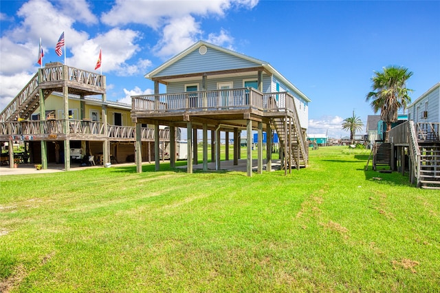 back of property featuring a deck and a lawn