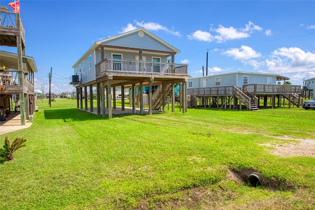 back of house with a yard and a wooden deck