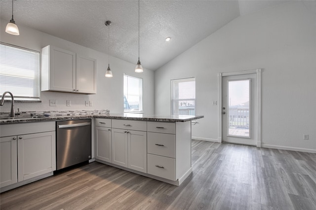 kitchen featuring dishwasher, hanging light fixtures, kitchen peninsula, sink, and white cabinets